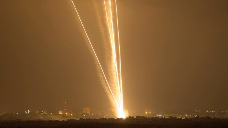 Light streaks and smoke trails are seen as rockets are launched from Gaza towards Israel today. Photograph: Amir Cohen/Reuters