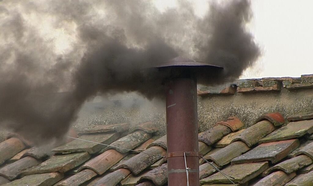 Black smoke rises from the chimney on the Sistine Chapel this morning. Photograph: Reuters