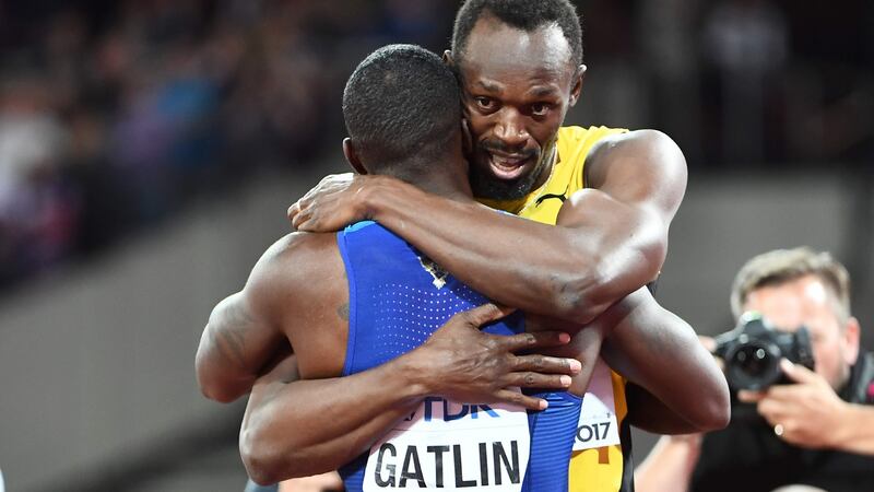 Bolt and Gatlin embrace after the race. Photo: Jewel Samad/Getty Images