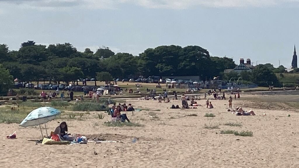 Sun bathers enjoy beach in Holywood on the shores of Belfast Lough. File photograph: Rebecca Black/PA Wire