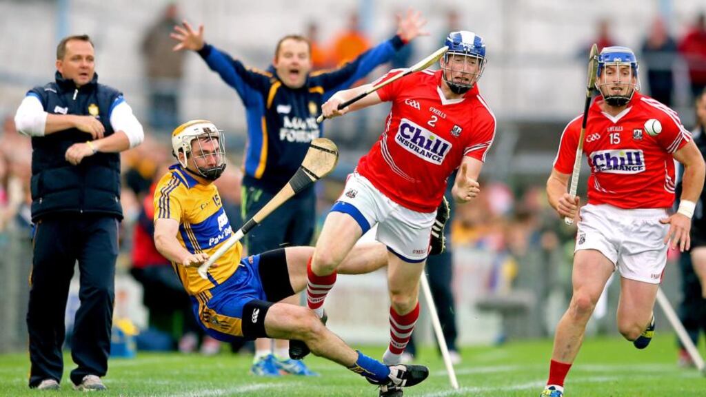 Clare’s Conor McGrath and Damien Cahalane of Cork clash during their qualifier round two meeting in Thurles. Photograph: James Crombie/Inpho