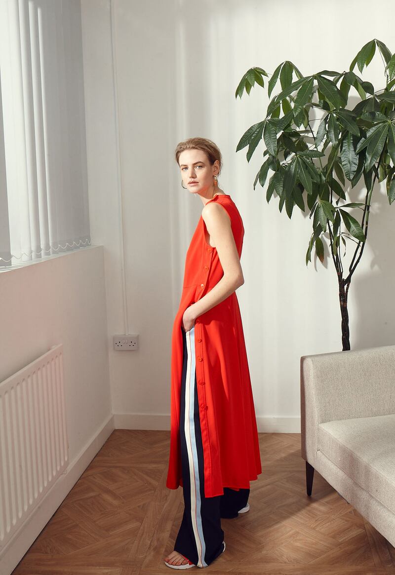 Red dress €270 Calvin Klein, navy stripe trousers €175 Marella, earrings €85 Dyrberg/Kern, West Elm Andes corner sofa €2699
