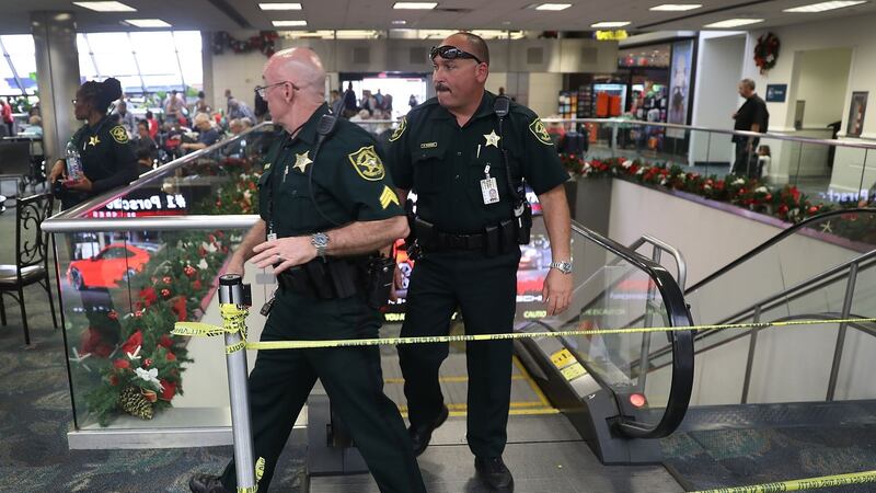 Broward County Sheriff officers exit from the escalator that takes people from the baggage area of Terminal 2. Photograph: Joe Raedle/Getty Images