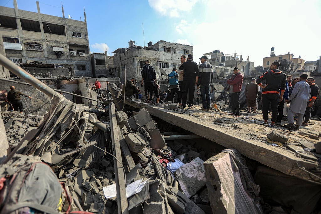 Palestinian men surveying the damage after an Israeli air strike on Khan Younis, southern Gaza, on December 1st, 2023. Photograph: Yousef Masoud/The New York Times