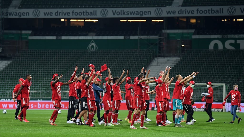 Bayern Munich players celebrate securing the Bundesliga title in front of empty stands after beating Werder Bremen at Wohninvest Weserstadion. Photo: Stuart Franklin/EPA