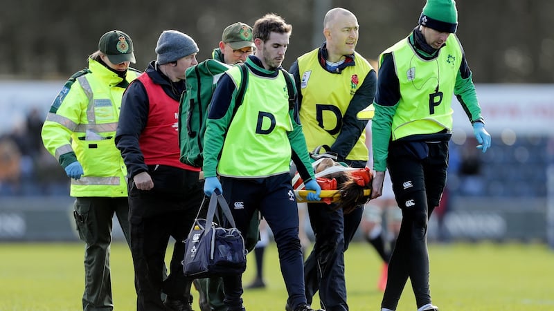 Naoupu is stretchered off with an injury during the loss to England in February. Photo: Laszlo Geczo/Inpho