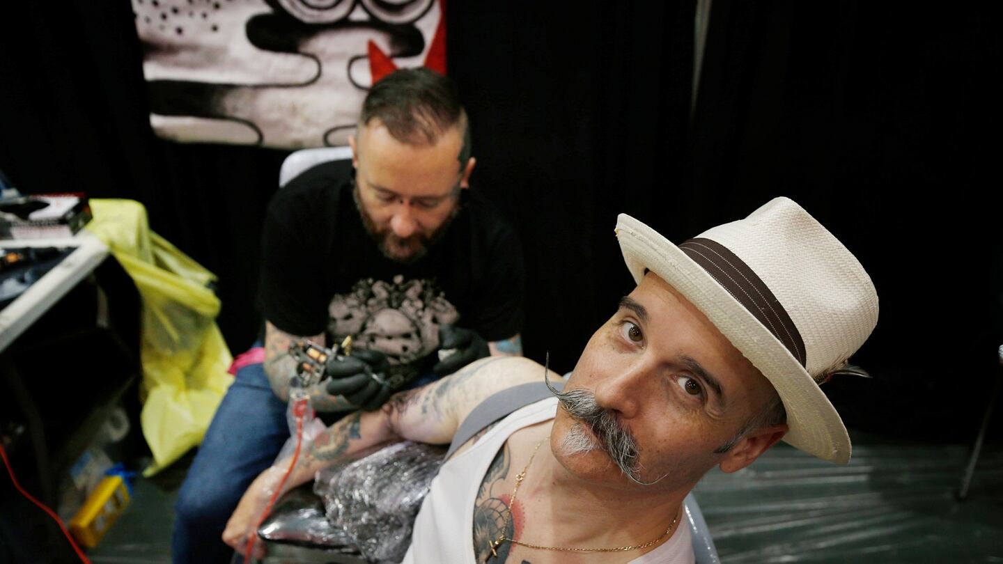 Tattoo artist Angus Wall, AWOL Tattoos and subject Christian Hoey, Dublin at the Dublin Tattoo Convention. Photograph Nick Bradshaw
