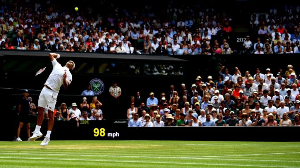 Roger Federer serves against Adrian Mannarino during their men’s singles fourth-round match on Centre Court at Wimbledon. Photograph: Clive Mason/Getty Images)