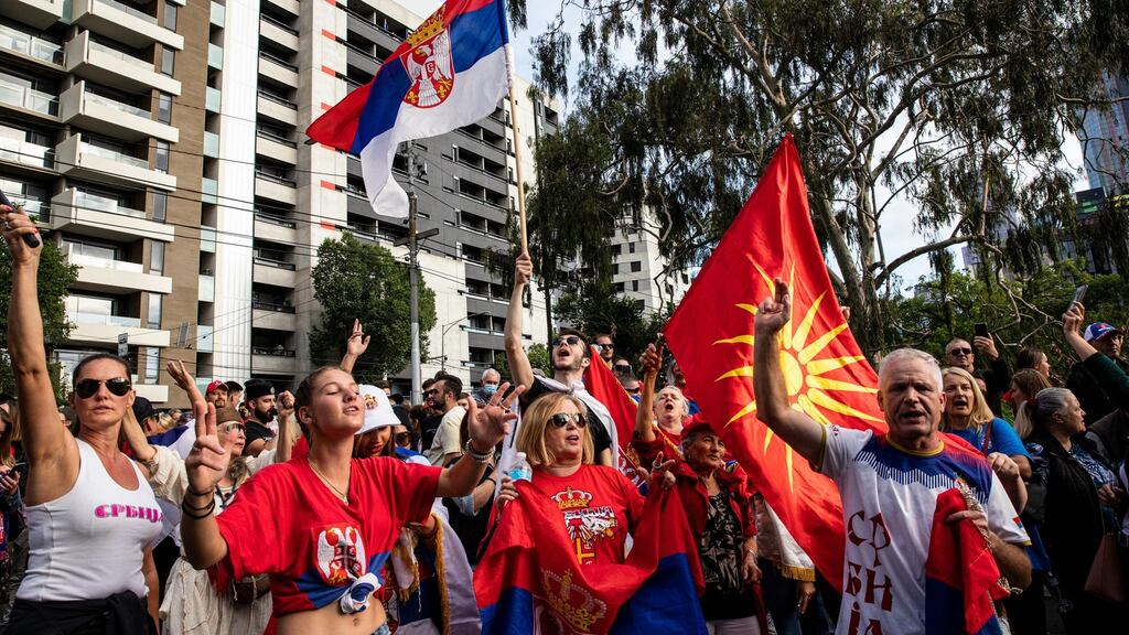 Serbian tennis fans and anti-vaccination protesters rally outside the Park hotel Saturday in Melbourne, where Novak Djokovic is staying ahead. Photograph: Diego Fedele/Getty Images
