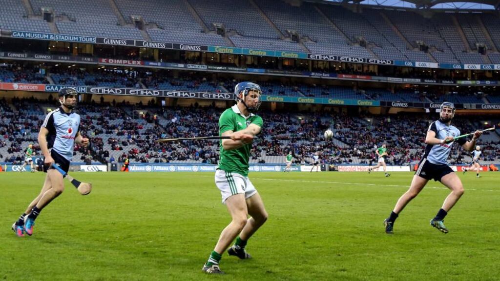 Limerick’s Conor Allis clears the danger as Danny Sutcliffe and Simon Lambert of Dublin look on during Saturday night’s clash at Croke Park. Photograph: Cathal Noonan/Inpho