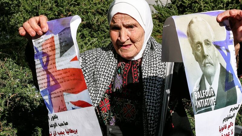 An elderly Palestinian woman tears up a photograph of Arthur Balfour during a protest on the centenary of the Balfour declaration outside the British embassy in Beirut. Photograph: Nabil Mounzer