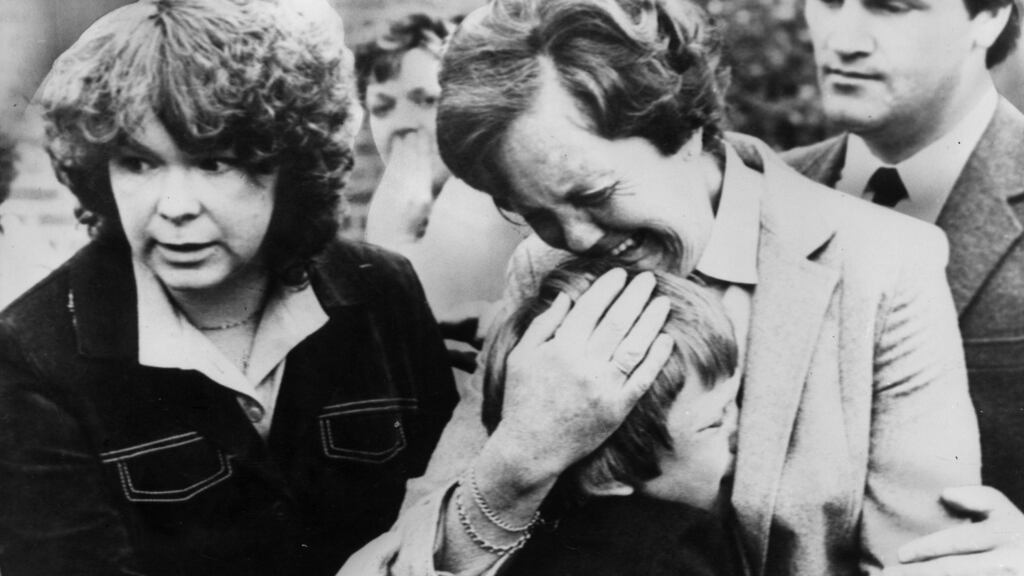 A mother comforts her young son at the the funeral of his murdered brother. Photograph: Keystone/Getty Images