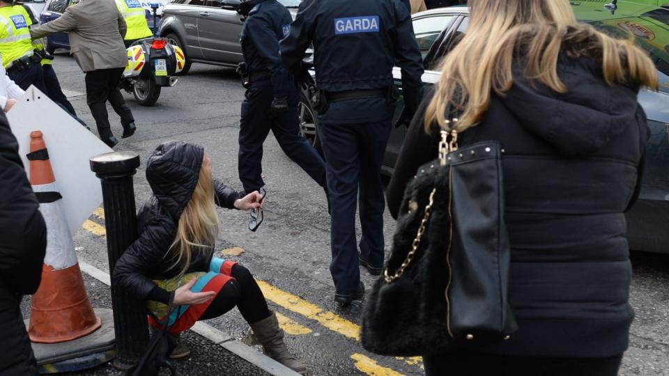 Protesters: a demonstrator on the ground after being pushed away from blocking Taoiseach Enda Kenny’s car outside Mansion House in Dublin. Photograph: Dara Mac Dónaill