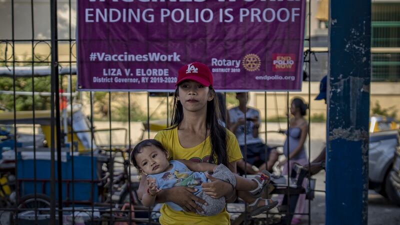 A parent brings her child to be administered an oral polio vaccine during a mass vaccination campaign in Manila, Philippines. The Philippines is aiming to vaccinate more than nine million children after the country’s health department announced an outbreak of polio, 19 years after the World Health Organisation declared the country free of the infectious disease. Photograph: Ezra Acayan/Getty Images