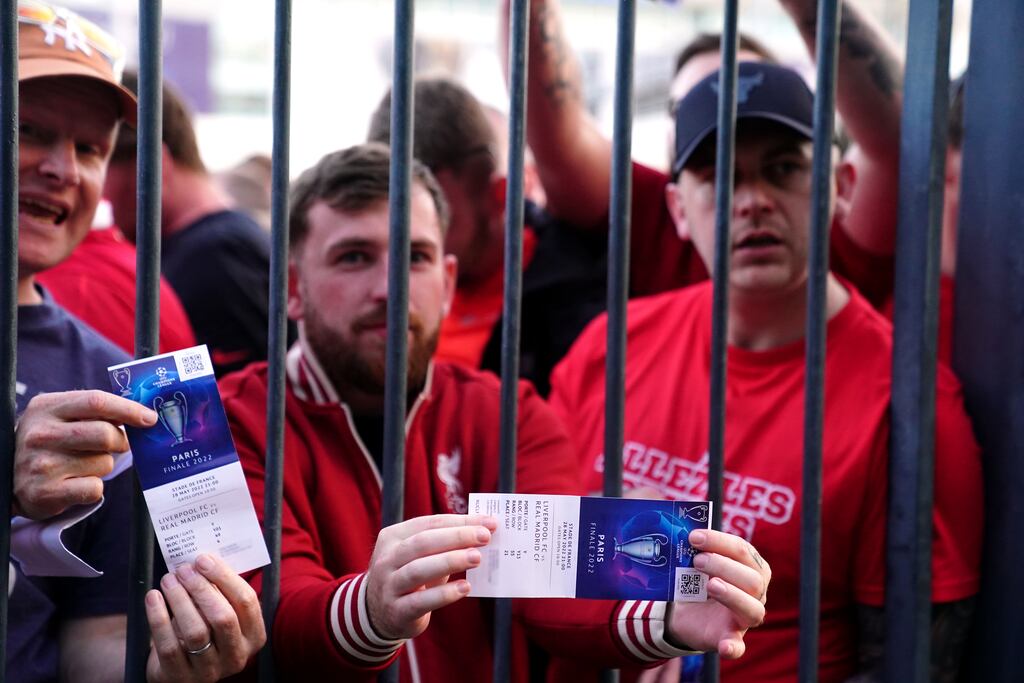 Liverpool fans stuck outside the ground show their match tickets. Photograph: Adam Davy/PA