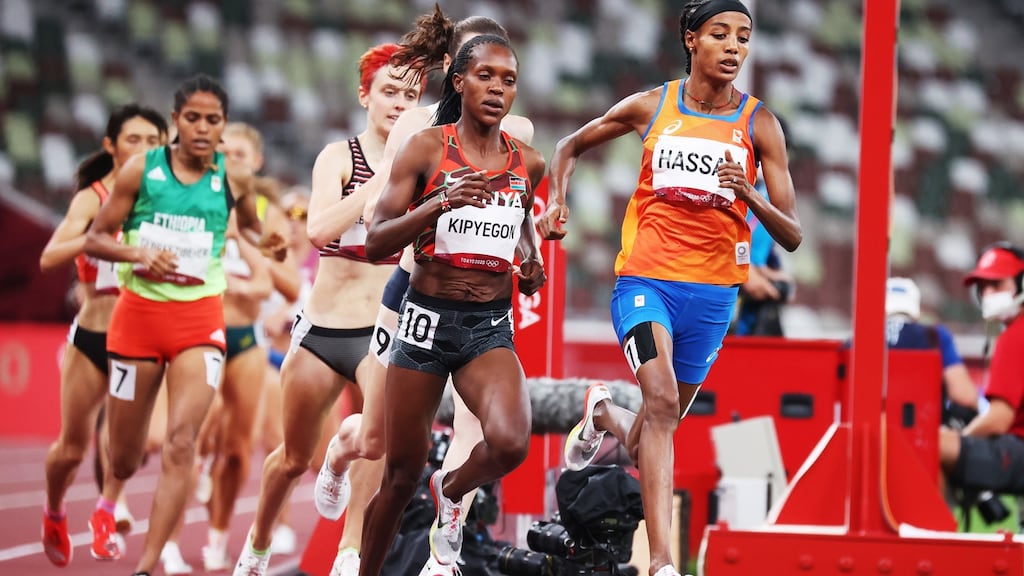 Faith Kipyegon of Kenya goes past Sifan Hassan of the Netherlands on her way to winning gold in the women’s 1,500m final at the Olympic Stadium in Tokyo. Photograph: Diego Azubel/EPA