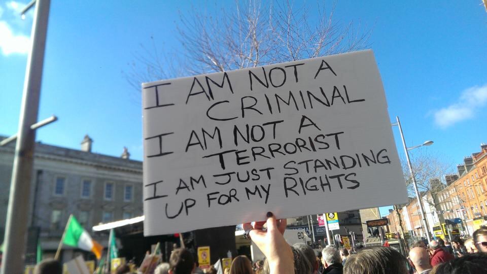 Demonstraters hold placards at the rally on O’Connell Street. Photograph: Pamela Duncan