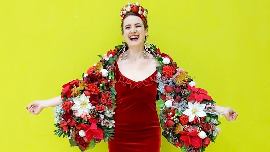 Taryn de Vere wearing a red velvet dress – a gift from her mother about 20 years ago – which she upcycled with glitter. The headpiece, earrings and wrap she made herself