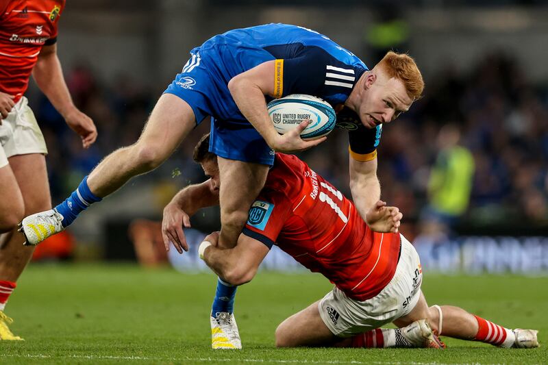 Leinster's Ciarán Frawley is tackled by Shane Daly of Munster during the
BKT United Rugby Championship match at the Aviva Stadium. Photograph: Ben Brady/Inpho