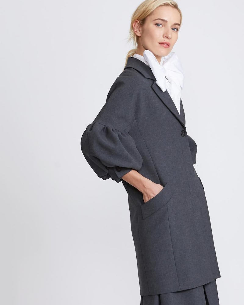 Peter O’Brien for Dunnes Stores: bouffant coat in yarn dyed grey crepe, €320; oversized white shirt with detachable bow, €120; grey culottes, €150