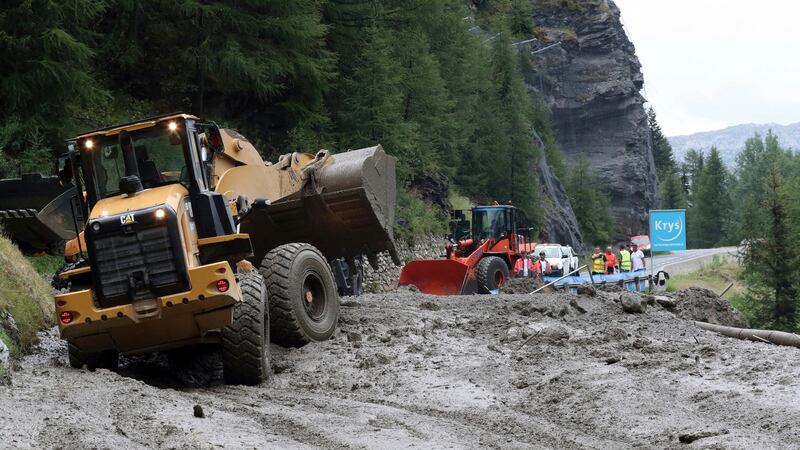 Workers use diggers to clear the road at the 19th stage of the Tour de France on Friday. Photograph: Thibault Camus/AP
