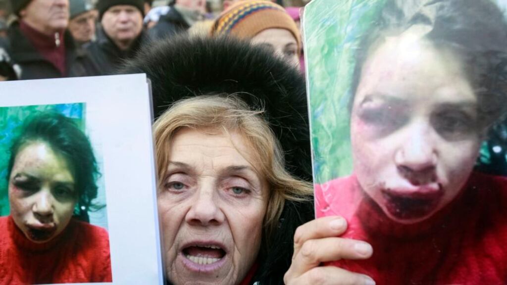 A protester holds pictures of journalist Tetyana Chornovil, who was beaten and left in a ditch just hours after publishing an article on the assets of top government officials, during a protest rally in front of the Ukrainian ministry of internal Affairs in Kiev. Photograph: Gleb Garanich/Reuters