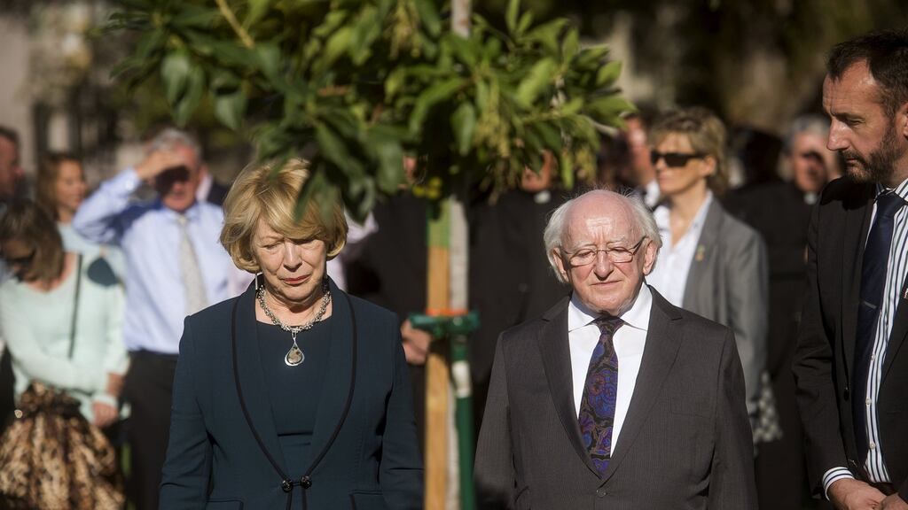 President Michael D Higgins and his wife Sabina Higgins pause in front of a tree planted to memorialise six students who died in Berkeley, California. Photograph:Noah Berger/Reuters