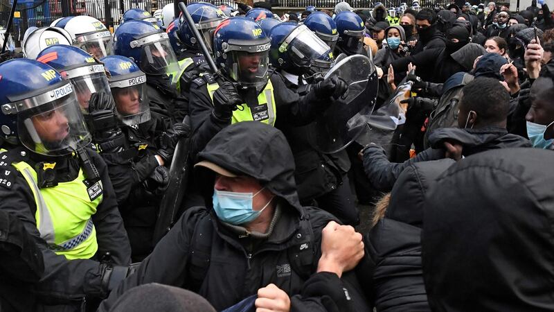 Protesters scuffle with police officers in riot gear near Downing Street, in London, during a demonstration organised to show solidarity with the Black Lives Matter movement. Photograph: Daniel Leal-Olivas/AFP via Getty Images