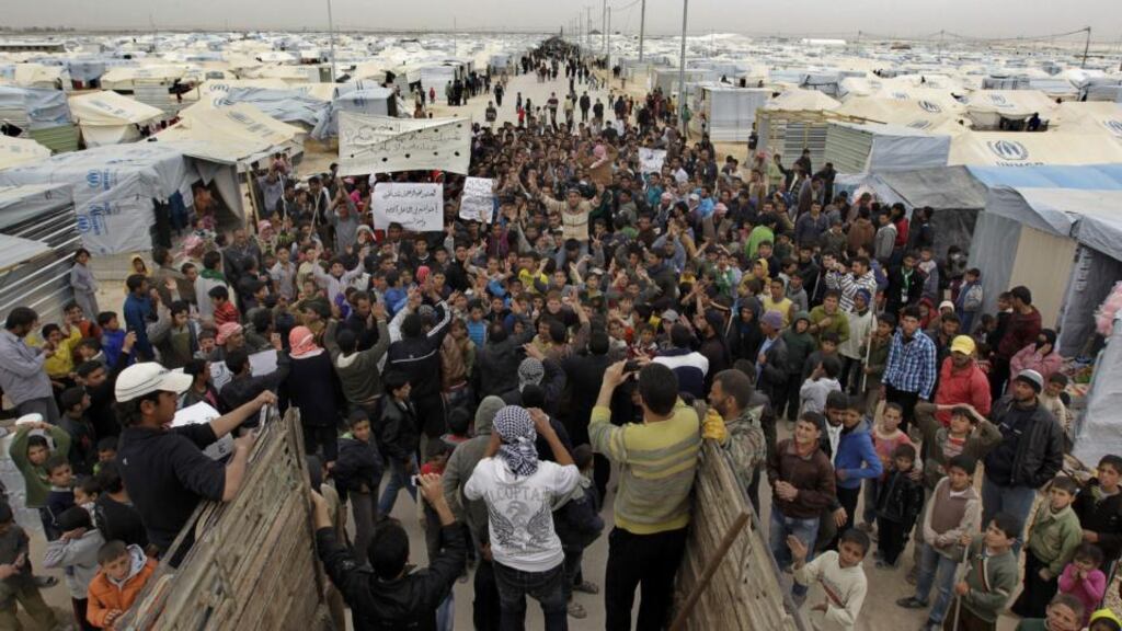 Syrian refugees at a demonstration at the Za’atari refugee camp, near the border with Syria, calling for the international community to arm the rebel Free Syrian Army, in February. Photograph: Khalil mazraawi/AFP/Getty