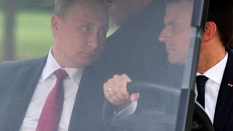 Emmanuel Macron driving an electric golf car with Russian president Vladimir Putin in the garden of the Versailles palace on Monday. Photograph: Alexei Nikolsky/Sputnik, Kremlin Pool Photo via AP
