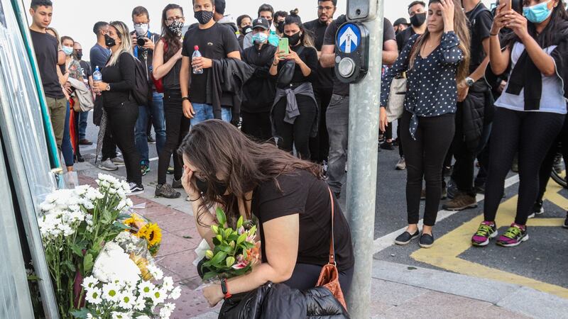 Theresa Dantas, fiancee of Deliveroo driver Thiago Osorio Corte, prays at the site where he was fatally injured in a collision on Monday night. Photograph: Damien Storan.