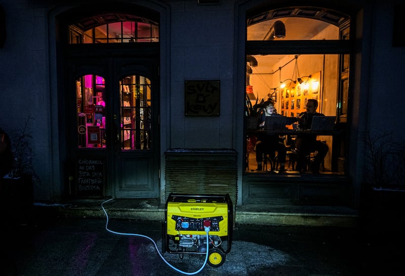 A cafe in Lviv with energy supplied by a power generator during a blackout. Photograph: Yuriy Dyachyshyn/AFP/Getty Images