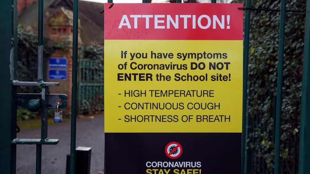 Coronavirus sign on the gates of a school in Reading, England. Photograph: Steve Parsons/PA Wire