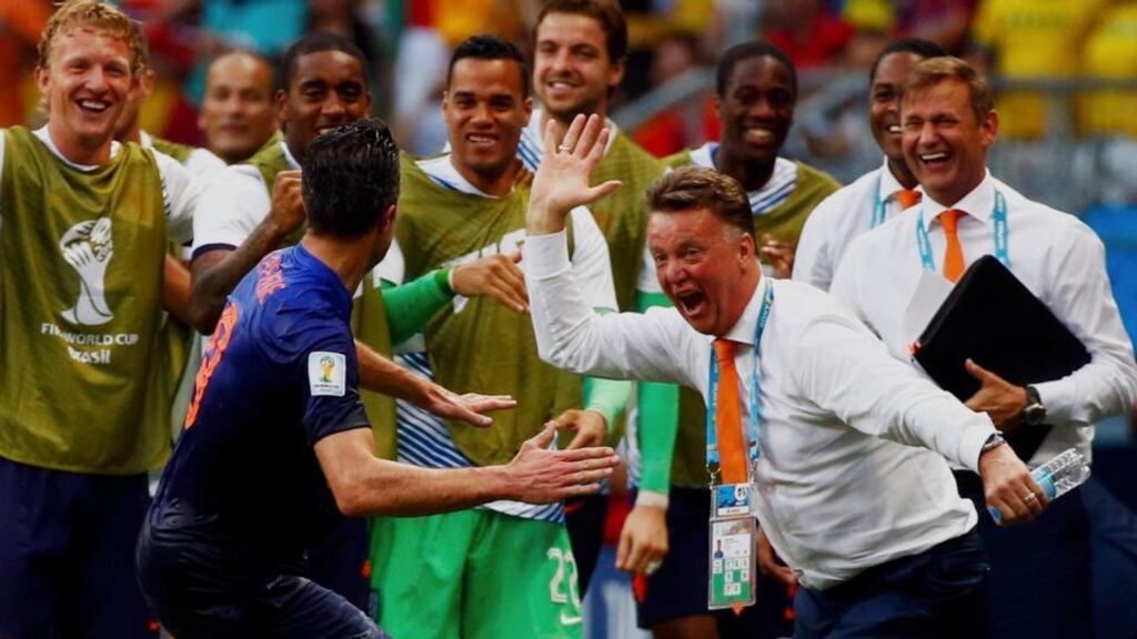 Robin van Persie of the Netherlands celebrates his goal against Spain with coach Louis van Gaal at the Fonte Nova arena in Salvador. Photo: Michael Dalder/Reuters