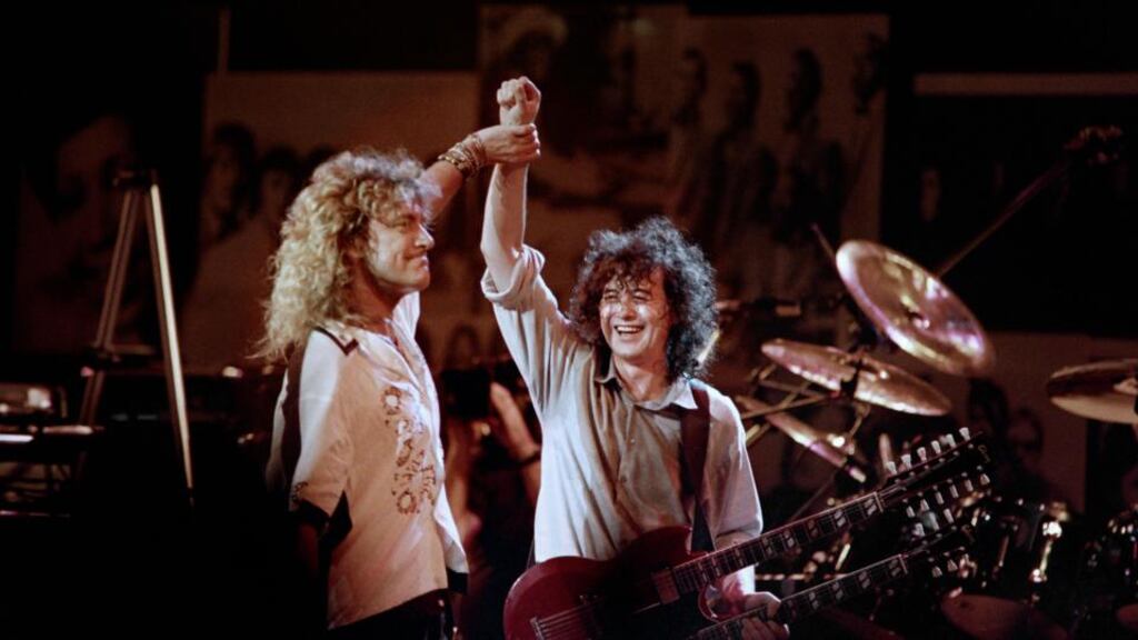 Robert Plant (left) holds hands raised high with guitarist Jimmy Page during a Led Zeppelin reunion performance at Madison Square Garden in New York on May 14th, 1988. Photograph: Don Emmert/AFP/Getty