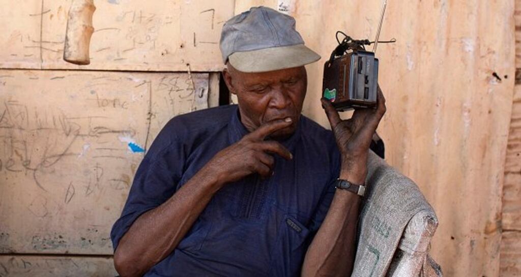 A man follows the latest provisional electoral results on the radio in Kibagare slum in Nairobi. Photograph: Siegfried Modola/Reuters
