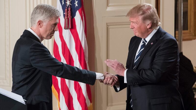 President Donald Trump shaking hands with Neil Gorsuch after announcing him as his nominee for the supreme court in January 2017. Photograph: Michael Reynolds/EPA