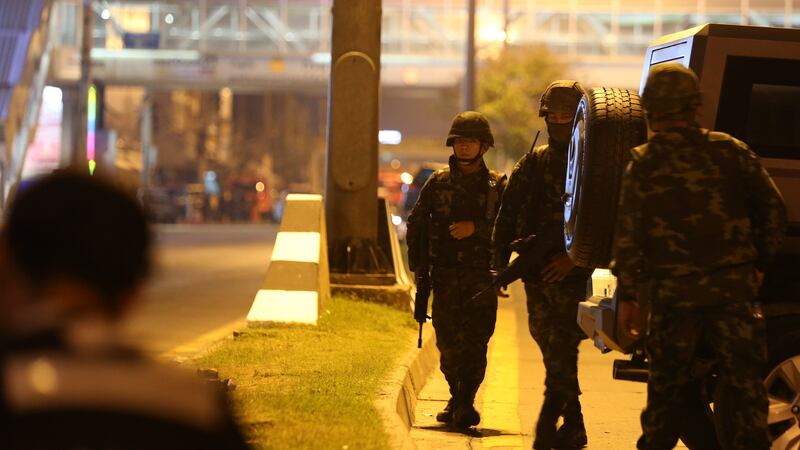Armed Thai soldiers on guard behind a defensive line, outside the shopping centre where a suspected Thai soldier opened fire in Nakhon Ratchasima province on Saturday. Photograph: Narong Sangnak/EPA