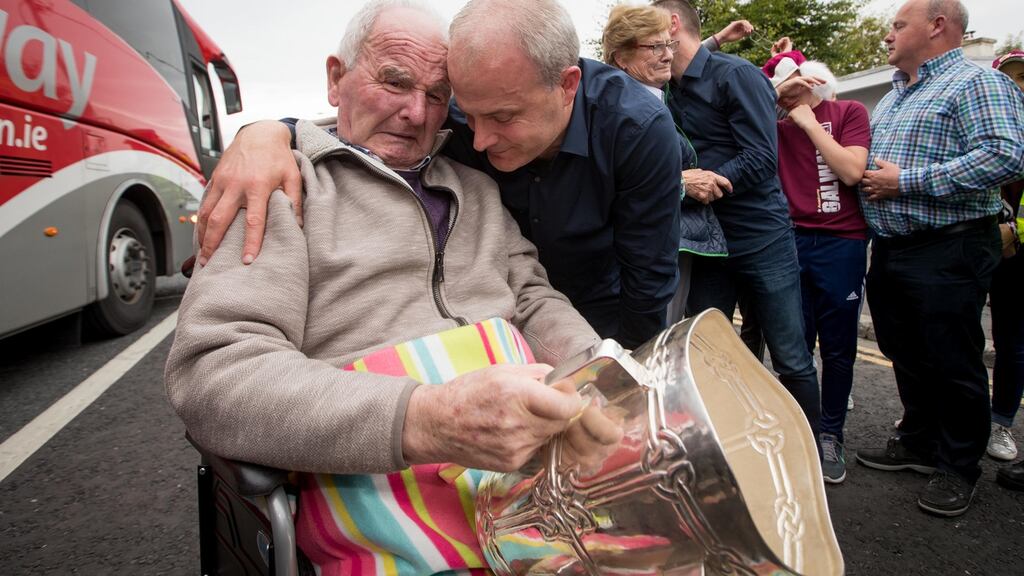 Galway manager Micheál Donoghue shows the Liam McCarthy to his father Miko Donoghue  in Ballinasloe following the All-Ireland win in 2017. Photograph: Morgan Treacy/Inpho