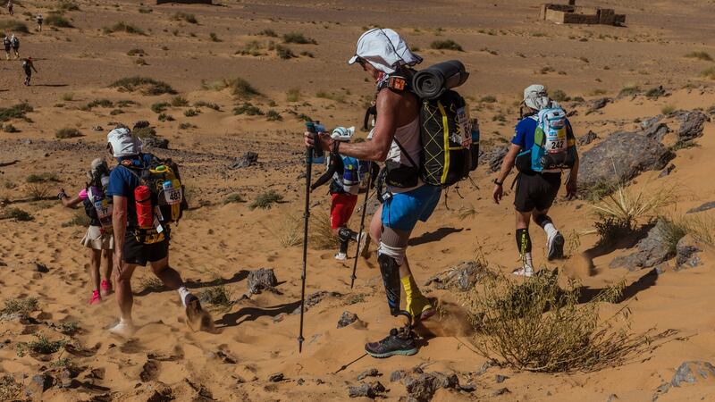 Amy Palmiero-Winters descends a rock-strewn hill. Photograph: Ryan Christopher Jones/The New York Times