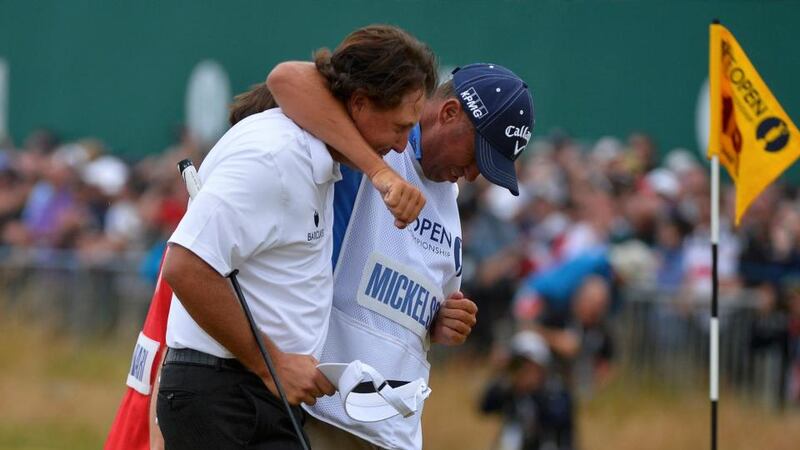 Phil Mickelson with his caddie Jim ‘Bones’ Mackay after making his birdie putt on the 18th. Photograph: Toby Melville/Reuters