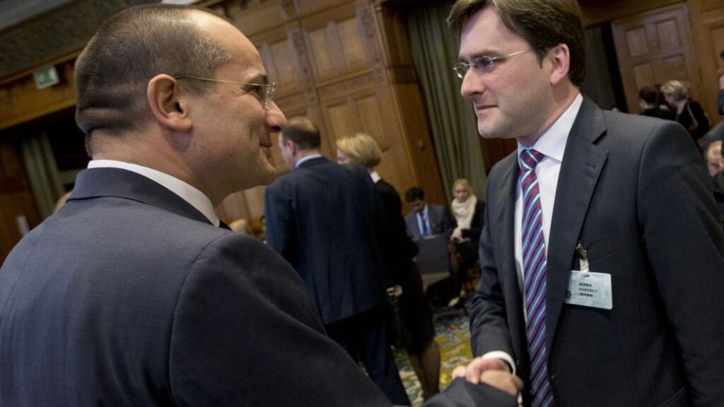 Croatia’s justice minister Orsat Miljenic (left) shakes hands with his Serbian counterpart Nikola Selkovic prior to a session of the International Court of Justice in The Hague  yesterday. Photograph: AP Photo/Peter Dejong