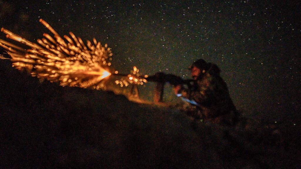 A Syrian Democratic Forces (SDF) fighter opens fire outside the Islamic State’s embattled holdout of Baghouz. Photograph: AFP/Getty Images