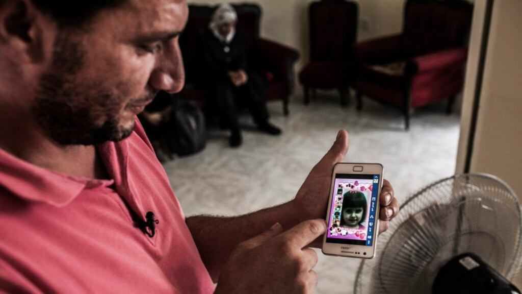 A Syrian refugee shows an image of his young daughter in Valetta, Malta.The girl drowned after the boat she was on sank in the Mediterranean sea. Photograph: EPA
