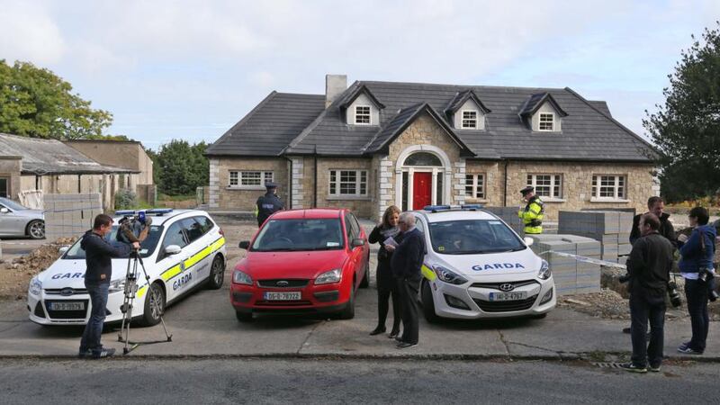 Gardai and reporters at the scene the shooting in Saggart, west Dublin, last night. A man in his forties was injured in the incident and later died in hospital. Photograph: Collins