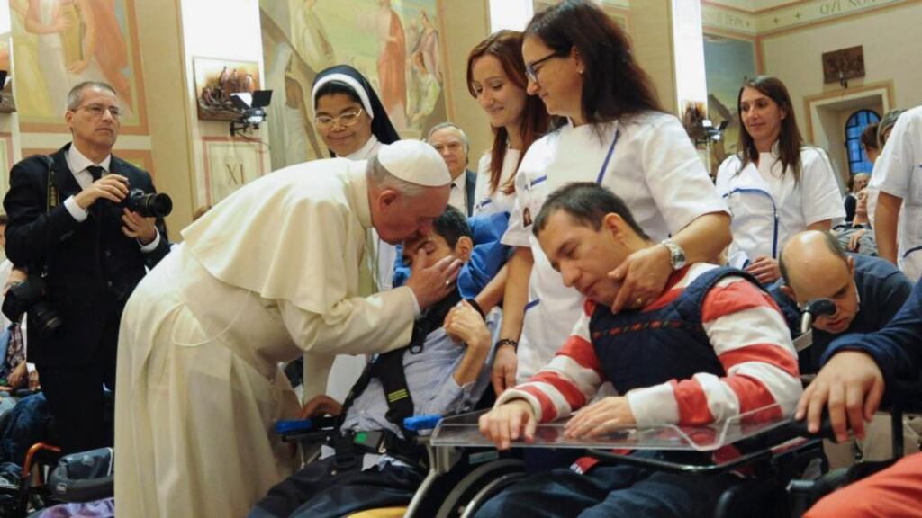 Pope Francis blesses a person with a disability during his visit at the Serafico Institue in Assisi. Photograph: Gian Matteo Crocchioni/Pool/Reuters