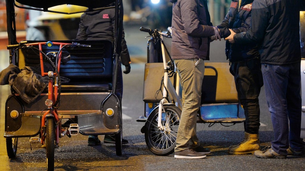 Undercover gardaí search and arrest a rickshaw driver on Suffolk Street, Dublin. Photograph: Alan Betson
