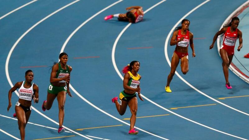 Allyson Felix of the US (top) on the ground after injuring her hamstring in the 200m final, as Shelly-Ann Fraser-Pryce of Jamaica (bottom centre) sprints to victory. Photograph: Denis Balibouse/Reuters