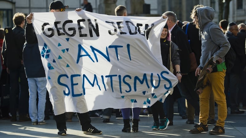 Activists hold a banner with the words ‘Against any kind of anti-Semitism’ at a “Wear a kippah” gathering in front of Cologne Cathedral. Photograph: Michael Gottschalk/ Getty Images