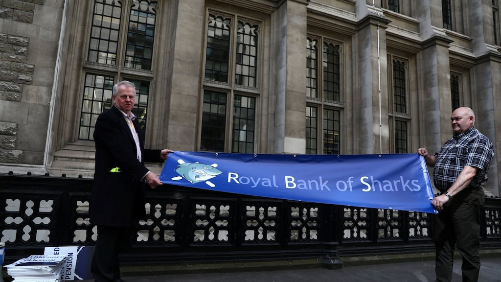 Protestors hold a banner outside of the Royal Courts of Justice as RBS pursued last-minute settlement talks with a group of investors to a trial over allegations the lender misled them about a 2008 capital increase. Photograph: Neil Hall/Reuters